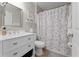 Bathroom with white vanity, marble shower curtain, and matching wall decor at 2507 Talega Dr, St Cloud, FL 34772
