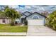Charming single-Gathering home featuring a two-car garage, mature landscaping, and a welcoming entrance at 2507 Talega Dr, St Cloud, FL 34772