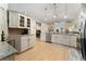Bright kitchen featuring granite counters, wooden floors, stainless appliances, and modern lighting at 2507 Talega Dr, St Cloud, FL 34772