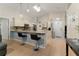 Open kitchen features an eat-in bar, stainless appliances, granite counters, and pendant lighting at 2507 Talega Dr, St Cloud, FL 34772