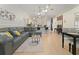 Open-concept living room featuring wood flooring, high ceilings, modern furnishings, and a kitchen view at 2507 Talega Dr, St Cloud, FL 34772
