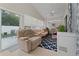 Enclosed sunroom featuring a variety of seating options, ceiling fan, and tile flooring at 2507 Talega Dr, St Cloud, FL 34772