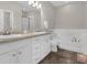 Bathroom with double sink vanity, tub, and white cabinets at 2621 Amati Dr, Kissimmee, FL 34741