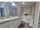 Bright bathroom features double sinks, bathtub, walk-in shower, and a neutral color palette at 2621 Amati Dr, Kissimmee, FL 34741