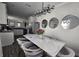 Modern dining room with stylish light fixture, marble table and seating for elegant dining at 2621 Amati Dr, Kissimmee, FL 34741