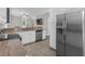 Open-concept kitchen with stainless steel fridge and views of living spaces at 2621 Amati Dr, Kissimmee, FL 34741