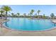 Large community pool with palm trees and lounge seating, perfect for relaxation at 2621 Amati Dr, Kissimmee, FL 34741