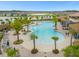 Aerial view of a resort-style pool with lush landscaping and plenty of lounge chairs at 2621 Amati Dr, Kissimmee, FL 34741