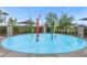 Fun splash pad with colorful water features and a nearby shaded seating area at 2621 Amati Dr, Kissimmee, FL 34741