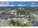 Aerial view of a community with houses, green spaces and surrounding farmland at 2679 Ridgetop Ln, Clermont, FL 34711