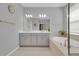 Bright bathroom with double vanity, soaking tub, and modern fixtures at 2679 Ridgetop Ln, Clermont, FL 34711