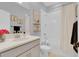 Bright bathroom featuring vanity, toilet, and shower-tub combination with light curtain at 2679 Ridgetop Ln, Clermont, FL 34711