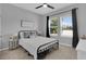 Bedroom with ceiling fan, natural light and black framed bed at 2679 Ridgetop Ln, Clermont, FL 34711