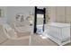 Bright Bedroom with a white crib, changing table and a comfortable chair at 2679 Ridgetop Ln, Clermont, FL 34711