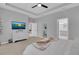 Relaxing bedroom featuring a TV, dresser, and a neutral color scheme at 2679 Ridgetop Ln, Clermont, FL 34711