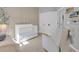 A Bedroom featuring a crib, cozy chair, and patterned accent wall at 2679 Ridgetop Ln, Clermont, FL 34711