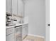 Butler pantry featuring gray cabinets, countertop appliances and a beverage center for added convenience at 2679 Ridgetop Ln, Clermont, FL 34711