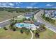 Aerial view of a community pool, playground, and surrounding green space at 2679 Ridgetop Ln, Clermont, FL 34711