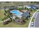 Aerial view of a resort-style community pool, playground, and lush landscaping at 2679 Ridgetop Ln, Clermont, FL 34711