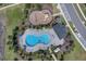 Birds eye view of a community pool with a unique shape and ample lounging at 2679 Ridgetop Ln, Clermont, FL 34711