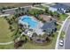 Aerial view of a community pool with a playground, and surrounding green space at 2679 Ridgetop Ln, Clermont, FL 34711