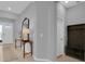 Inviting entryway with light wood floors, stylish console table, mirror, and coat rack for added convenience at 2679 Ridgetop Ln, Clermont, FL 34711