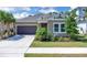 Charming single-story home with a well-manicured lawn, mature palm trees, and neutral stucco facade at 2679 Ridgetop Ln, Clermont, FL 34711