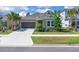 Charming single-story home features a well-manicured lawn, mature palm trees, and a neutral stucco facade at 2679 Ridgetop Ln, Clermont, FL 34711