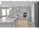 Modern kitchen with stainless steel appliances, a large island, and light gray cabinetry at 2679 Ridgetop Ln, Clermont, FL 34711