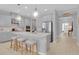 Open kitchen featuring a large island with seating, stainless steel appliances, and stylish pendant lights at 2679 Ridgetop Ln, Clermont, FL 34711