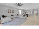 Open concept living room and kitchen with a large sectional sofa and modern decor at 2679 Ridgetop Ln, Clermont, FL 34711