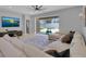 Bright living room with a large sectional sofa, flat screen TV, and sliding glass doors to the backyard at 2679 Ridgetop Ln, Clermont, FL 34711