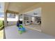 Covered patio with outdoor furniture, view to the spacious interior and backyard at 2679 Ridgetop Ln, Clermont, FL 34711