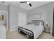 Cozy bedroom features soft carpet, ceiling fan, decor, and neutral color scheme at 2679 Ridgetop Ln, Clermont, FL 34711