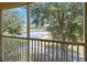 Serene balcony view overlooking a lush landscape and peaceful lake at 2826 Club Cortile Cir # B, Kissimmee, FL 34746