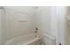 Bright bathroom features a tub and shower combination, toilet, and neutral finishes at 2826 Club Cortile Cir # B, Kissimmee, FL 34746