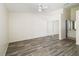 Bright bedroom with fan, mirrored closet, hardwood floors, and a view of the bathroom at 2826 Club Cortile Cir # B, Kissimmee, FL 34746