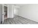 Spacious bedroom featuring wood-look flooring and access to the kitchen at 2826 Club Cortile Cir # B, Kissimmee, FL 34746
