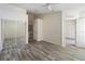 Bright bedroom featuring hardwood floors, ceiling fan, mirrored closet, and white trim at 2826 Club Cortile Cir # B, Kissimmee, FL 34746