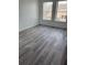 A light filled bedroom with gray vinyl plank flooring and large windows at 2826 Club Cortile Cir # B, Kissimmee, FL 34746