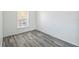 Bedroom featuring wood-look flooring and a window for natural light at 2826 Club Cortile Cir # B, Kissimmee, FL 34746