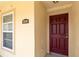 Close-up of the front entrance with red door and address marker at 2826 Club Cortile Cir # B, Kissimmee, FL 34746