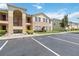 Well-maintained condo building with two stories, balconies, and manicured landscaping at 2826 Club Cortile Cir # B, Kissimmee, FL 34746
