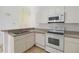 Bright kitchen featuring white appliances and ample cabinet space at 2826 Club Cortile Cir # B, Kissimmee, FL 34746