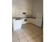 A well lit kitchen with white cabinets, tile floors, and new appliances at 2826 Club Cortile Cir # B, Kissimmee, FL 34746