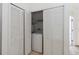 Laundry closet with bi-fold doors and a washer and shelf above at 2826 Club Cortile Cir # B, Kissimmee, FL 34746