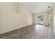 Bright living room with gray wood-look flooring and sliding glass door to a balcony at 2826 Club Cortile Cir # B, Kissimmee, FL 34746