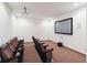 Home theater room with tiered seating, projector, screen, and surround sound at 2826 Club Cortile Cir # B, Kissimmee, FL 34746