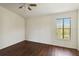 Bright bedroom with dark wood floors, and a ceiling fan at 2828 Club Cortile Cir # B, Kissimmee, FL 34746