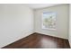 Bright, modern bedroom with gleaming wood floors and a sunlit window view at 2828 Club Cortile Cir # B, Kissimmee, FL 34746